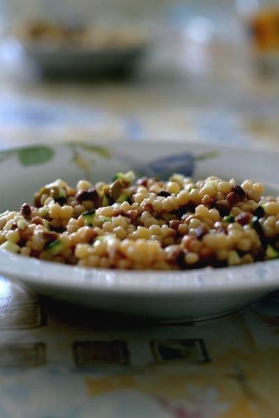 Fregula (fregola) with lentils and courgettes